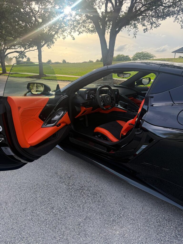 Orange leather interior of an exotic convertible, exotic car rental at 95 Auto Club Miami