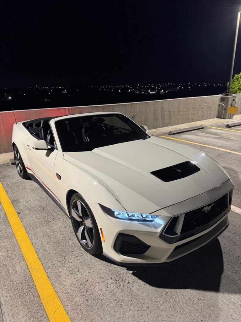 White convertible sports car at night, luxury car rental in Miami