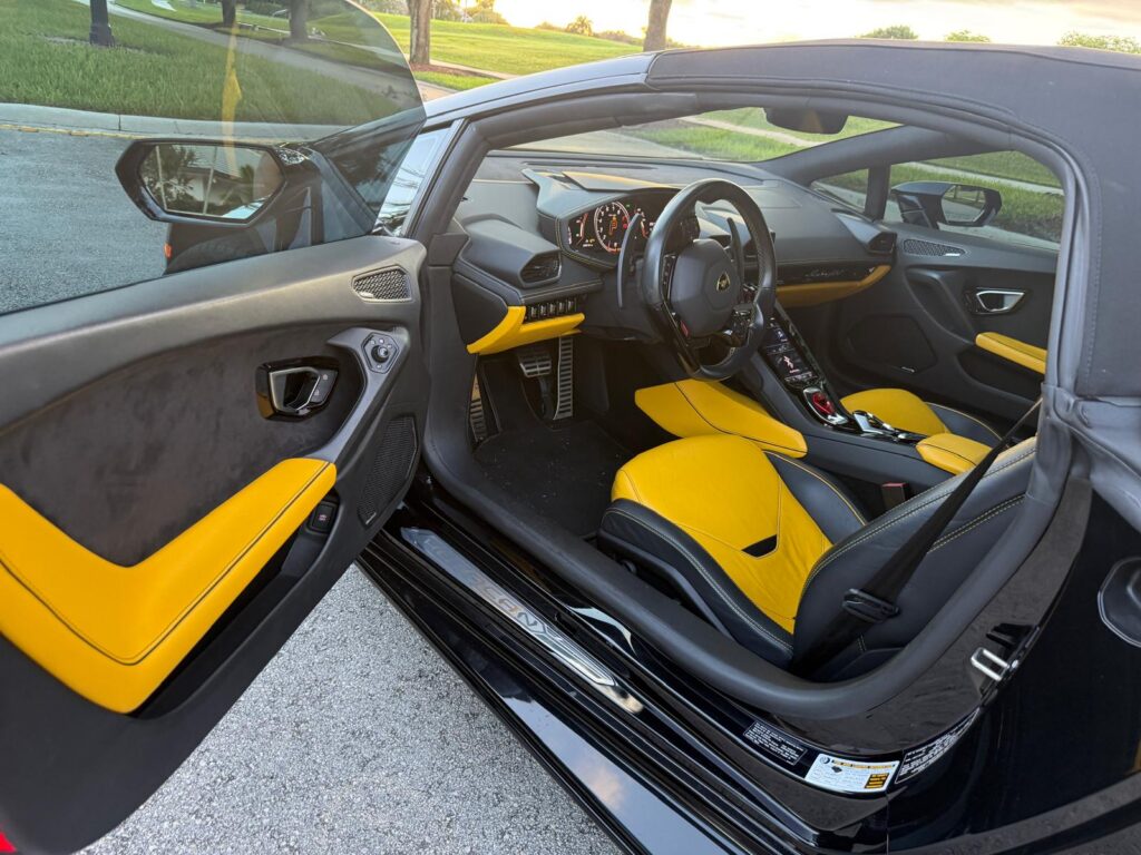 Lamborghini Huracán EVO Spyder yellow and black leather interior with the door open