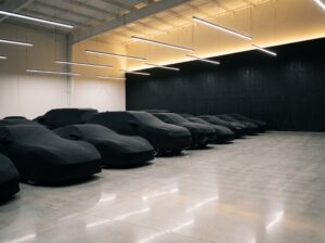 Covered exotic cars in private indoor storage