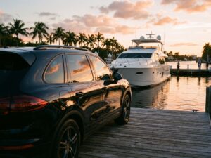 Black SUV delivered to a marina dock at sunset